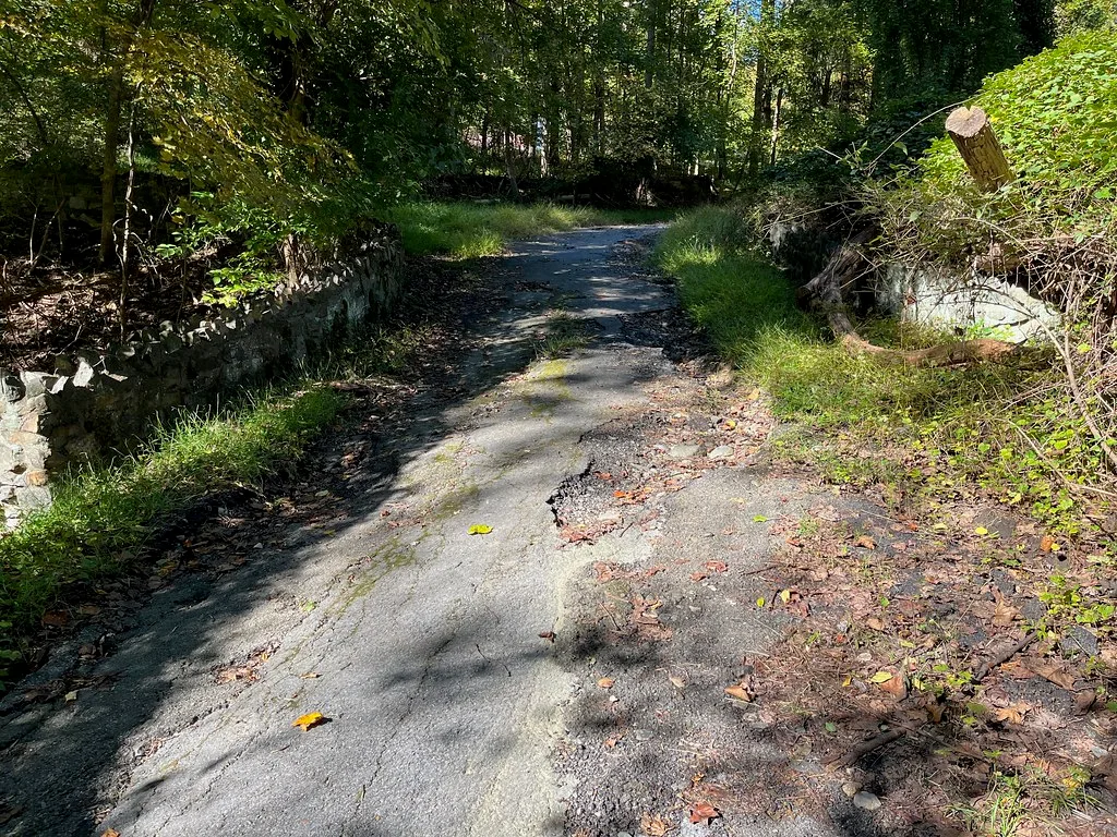 Damaged asphalt surface on spur trail, Gwynns Falls Trail, Baltimore, MD 21216