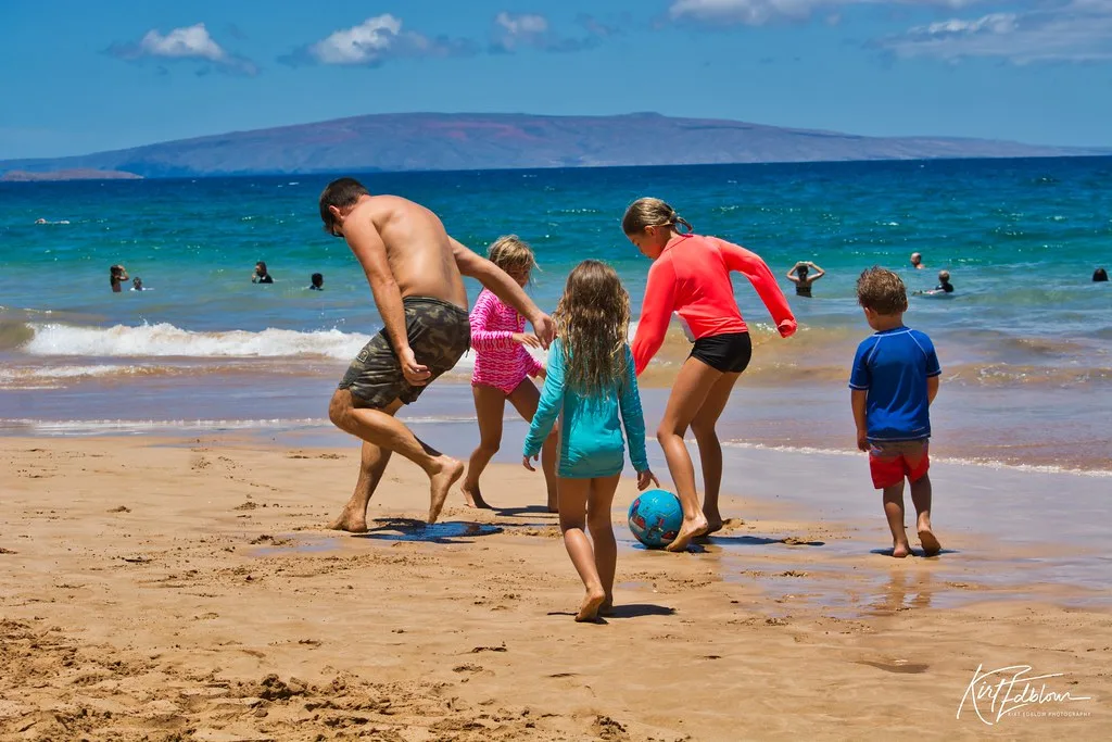 Family soccer on the beach